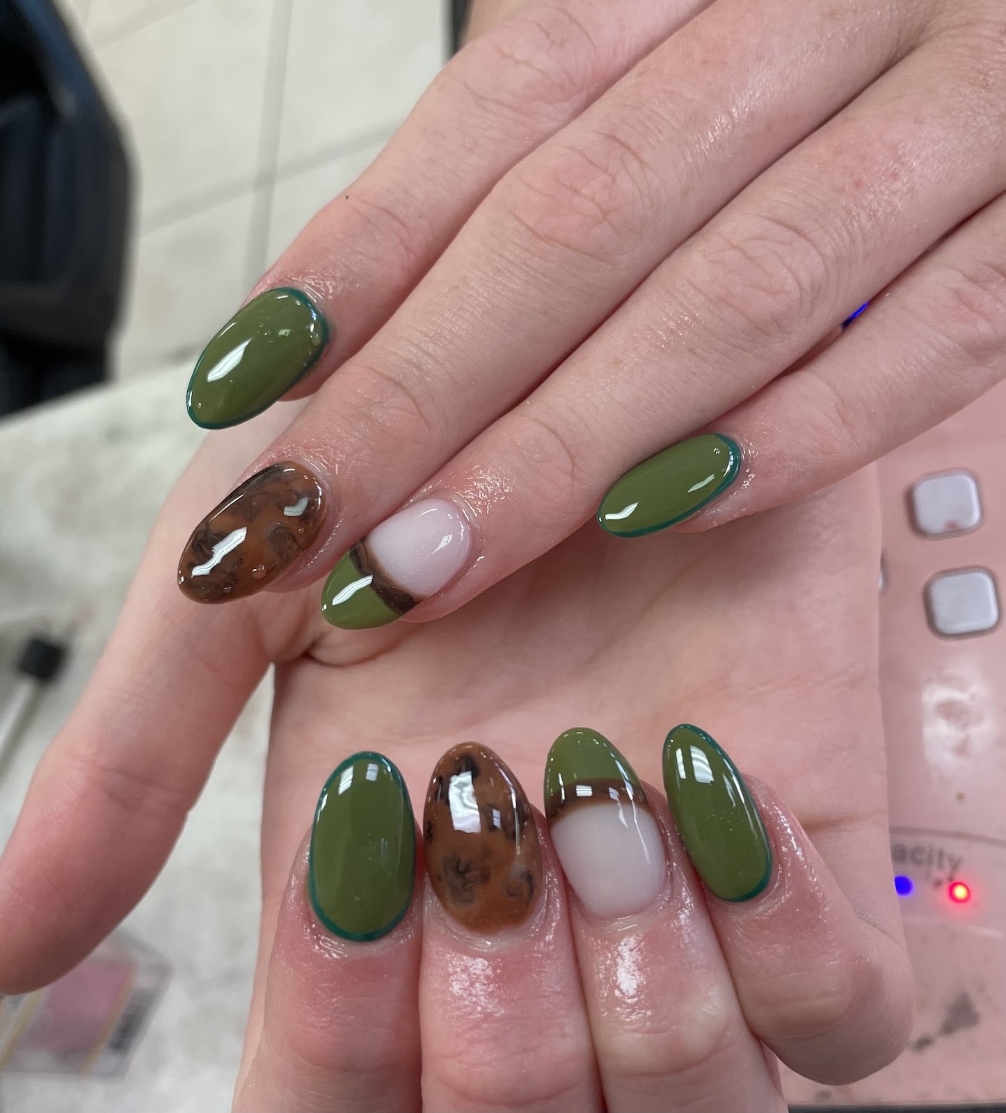 Olive green and tortoiseshell almond nails with milky accents