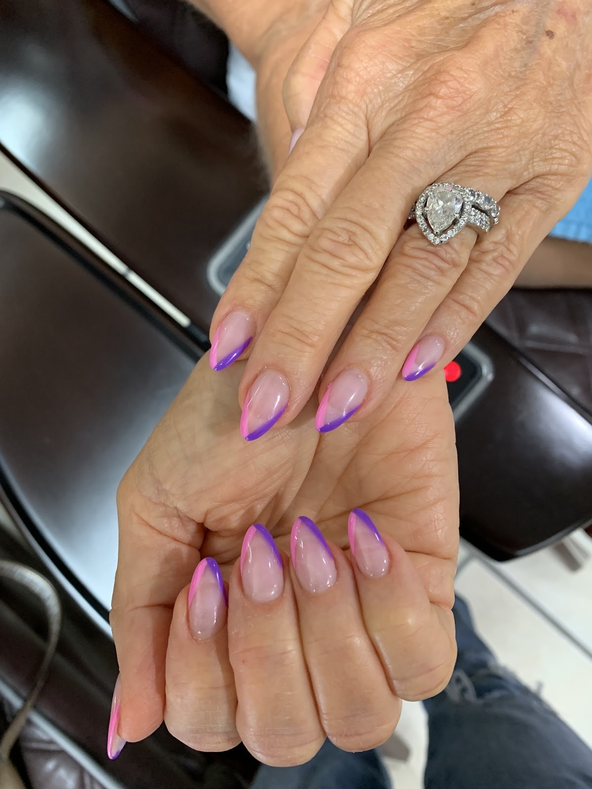 Sheer blush nails with purple and pink French tips, almond shape